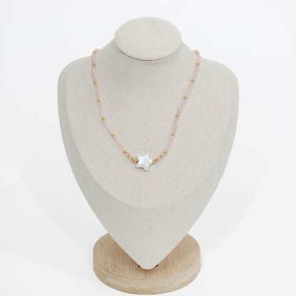bubble star choker Necklace in pink with star-shaped pendant on a mannequin bust against a white background