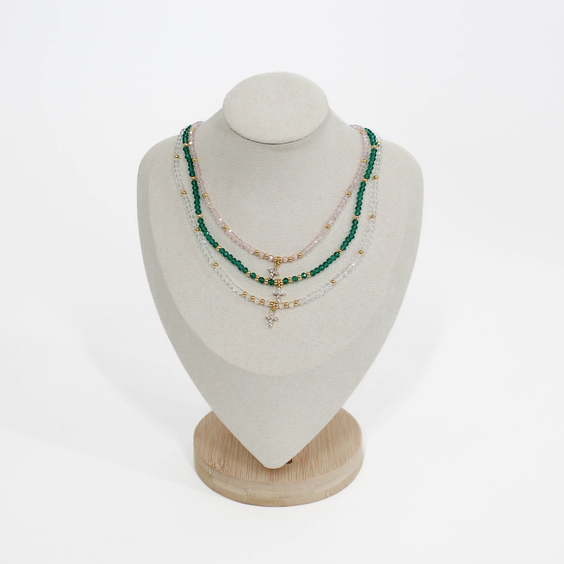 mini cross choker Necklaces on a mannequin bust with a white background