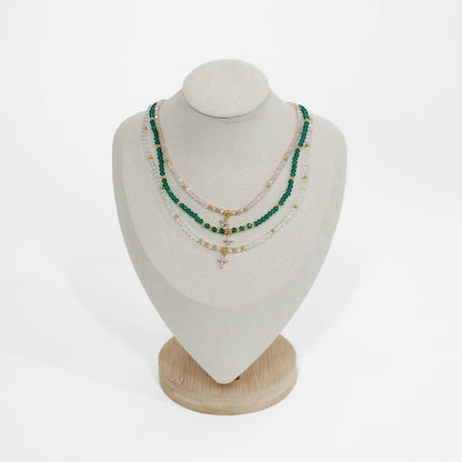 mini cross choker Necklaces on a mannequin bust with a white background