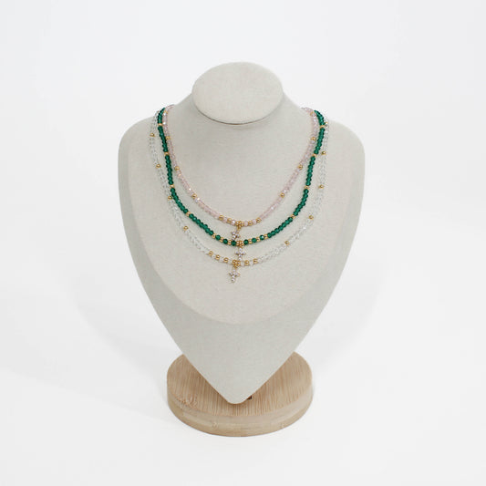 mini cross choker Necklaces on a mannequin bust with a white background