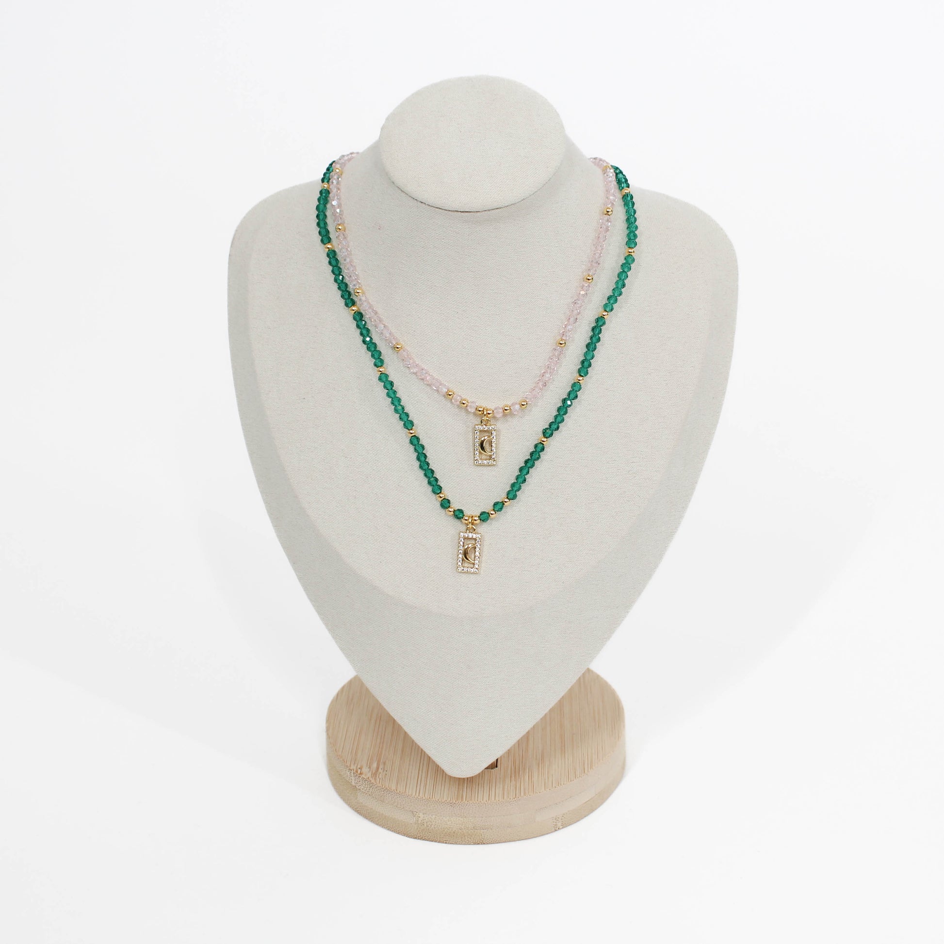 Green and pink beaded moon pave choker necklace on a mannequin bust with a white background