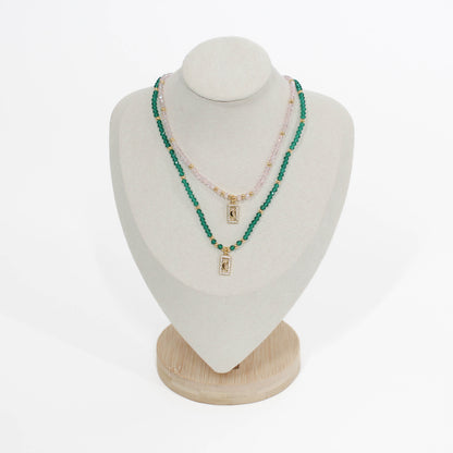 Green and pink beaded moon pave choker necklace on a mannequin bust with a white background