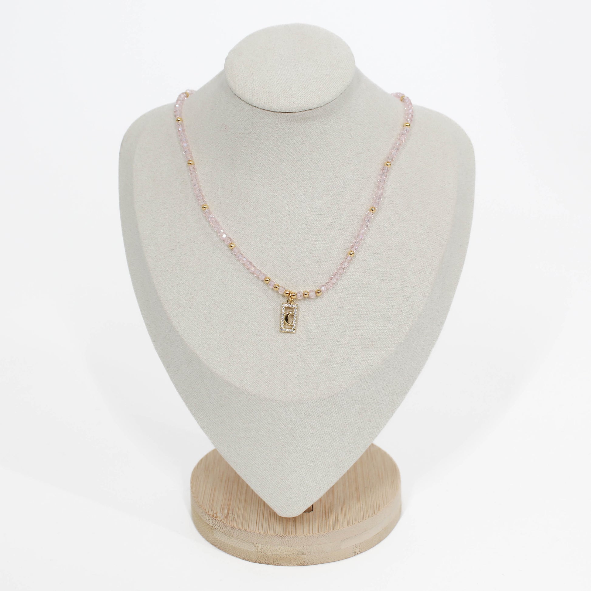 pink moon pave choker Necklace on a white mannequin bust with a plain background