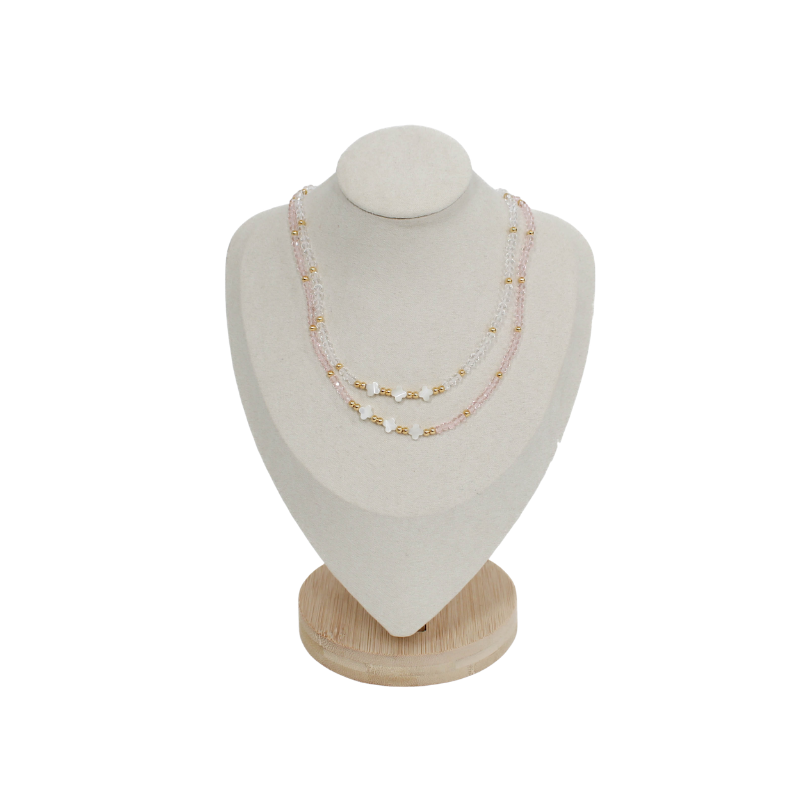 triple clover necklaces on a mannequin bust with a white background