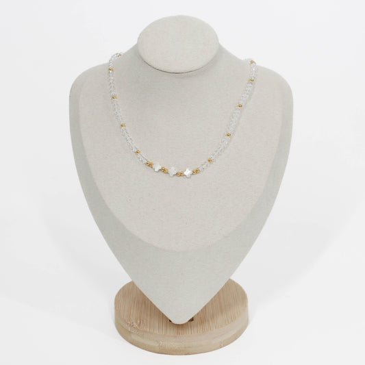 clear triple clover necklace on a white mannequin bust with a white gray background