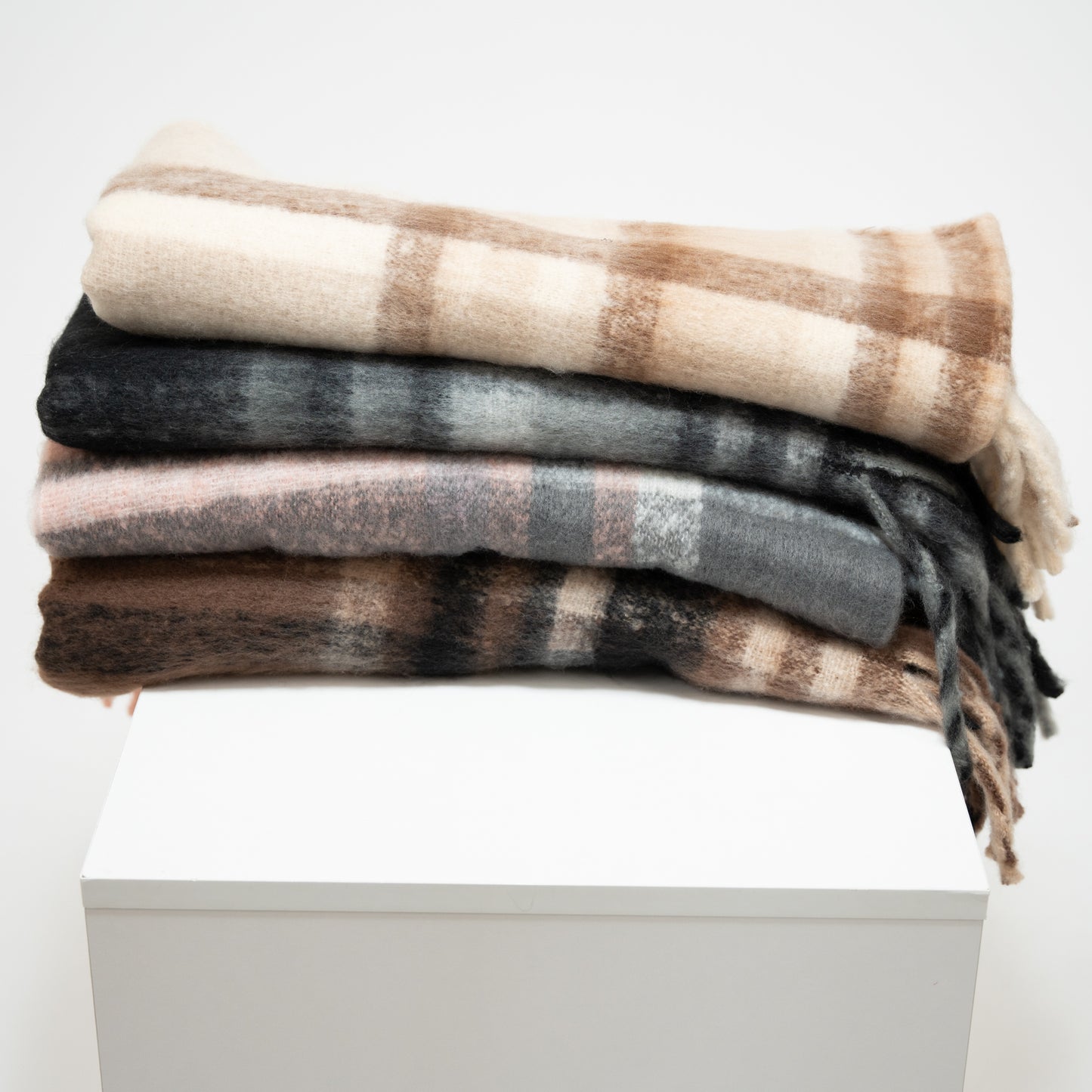 stack of plaid scarves